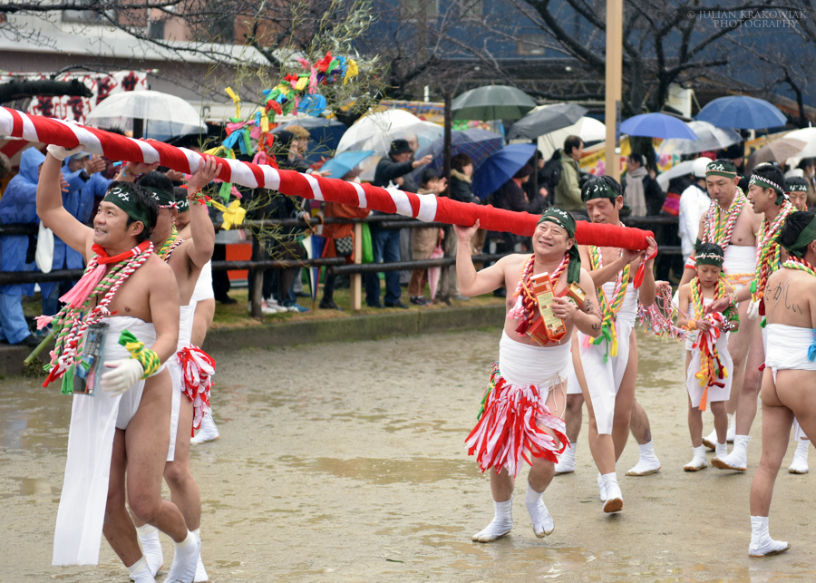 Participants of Naked Man festival are carrying a big ceremonial bamboo pole wrapped in long pieces of cloth. Sake helps them to stay warm during cold winter weather.