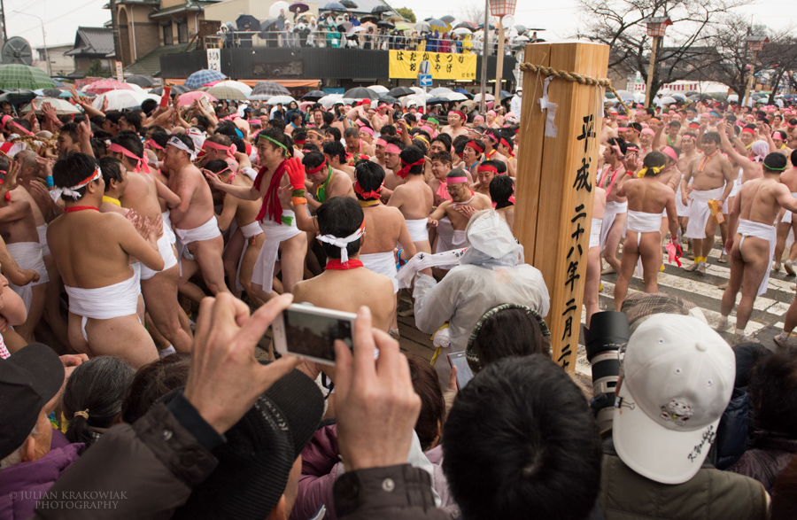 Festival participants wearing nothing but traditional Japanese underwear are reaching the main gate of Konomiya Shrine.